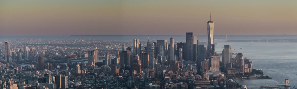 a large city with tall buildings next to a body of water