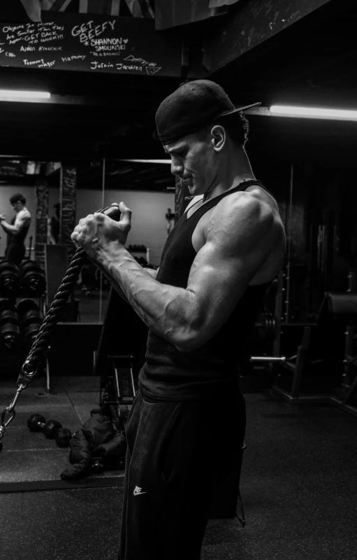 a man working out on a chain in a gym