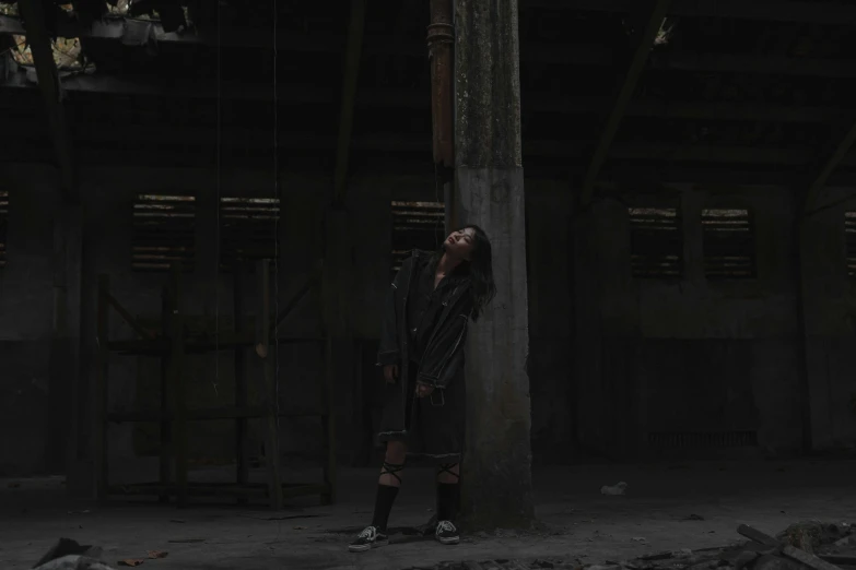 a person leaning against the corner of an old building