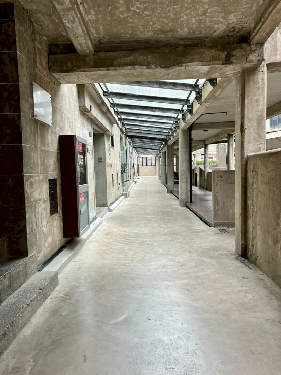 an empty concrete building with two booths