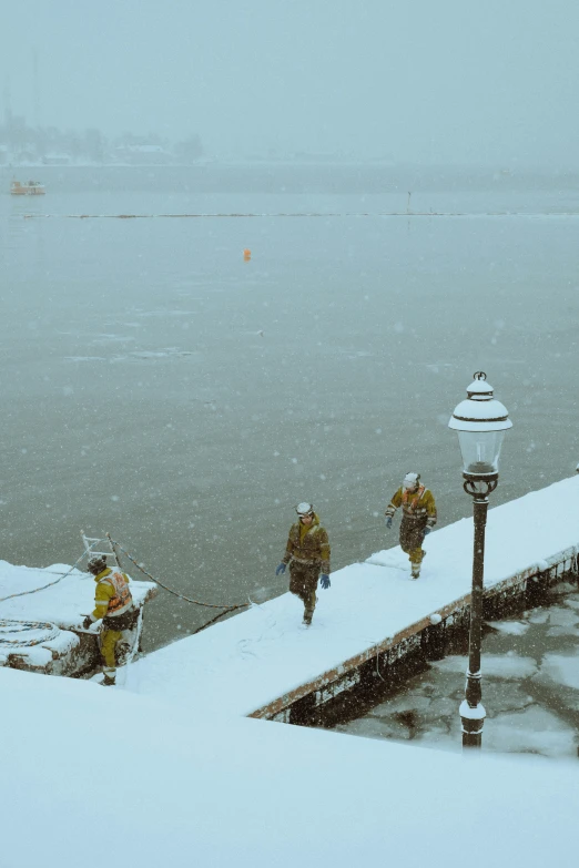 a group of people standing on top of a pier