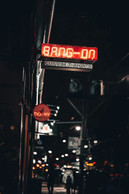 a red clock is sitting on the side of a building