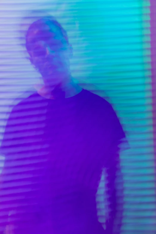 an abstract pograph of a man standing in front of a colored wall