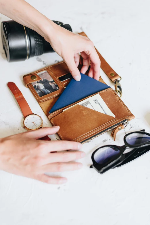 a person putting a passport into a case