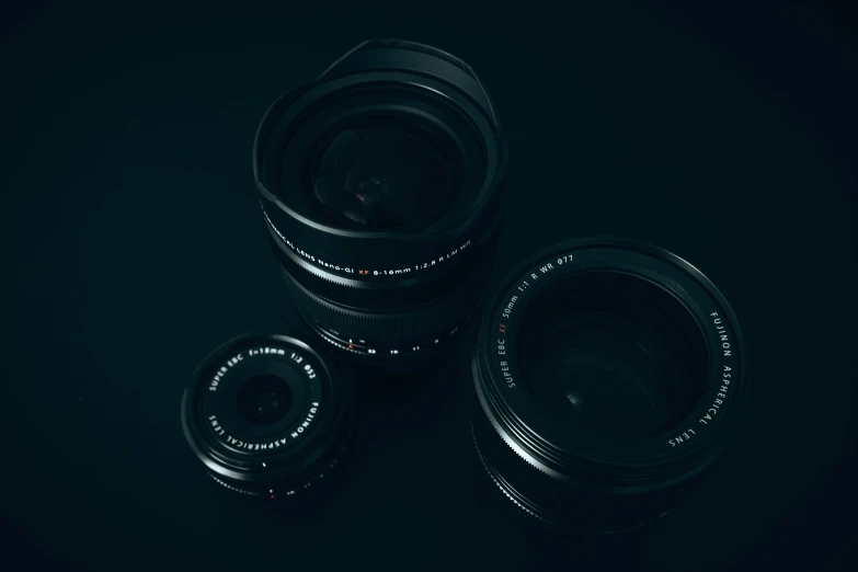 several different camera lens with no lids