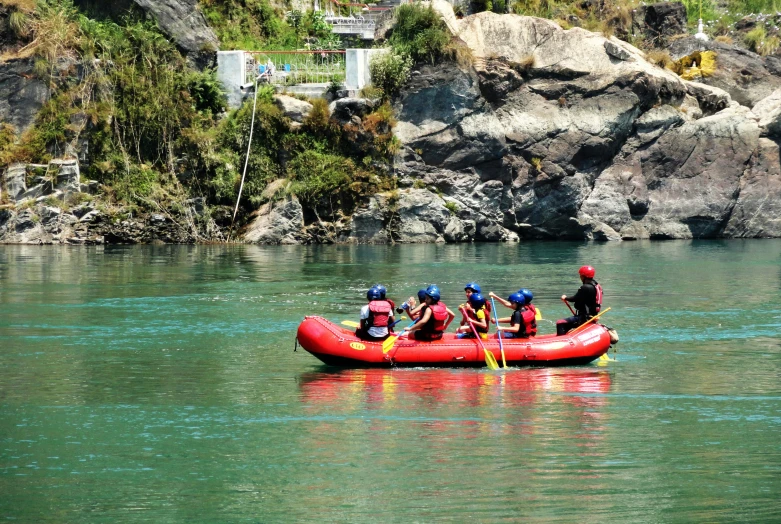 several people are in an inflatable raft in a river