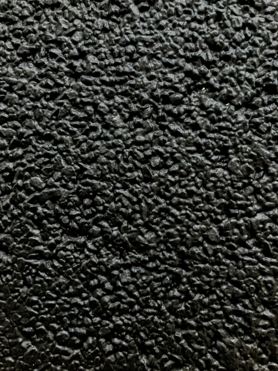 closeup of a gray textured surface with black dots