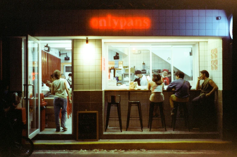 people at tables in front of the restaurant