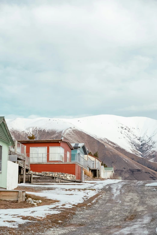 an image of many homes sitting near the mountains