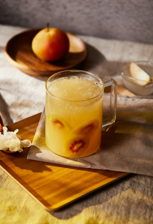 a wooden plate topped with fruit and a pitcher