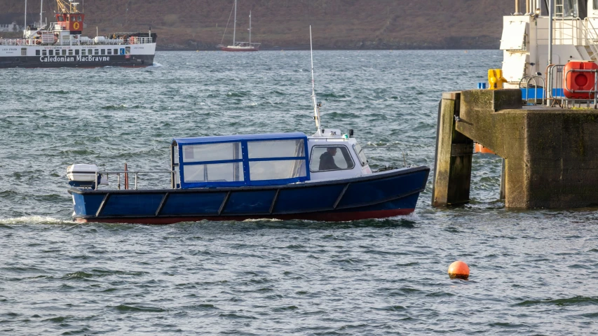 two boats in the water next to a dock