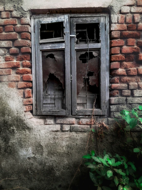 a very old window and brick wall on the side of a building