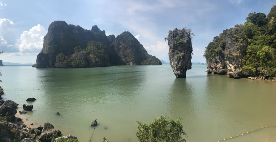 several small islands on the water with trees and plants