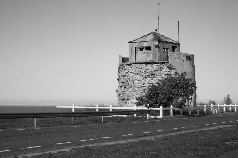 a tall tower sitting on the side of a road