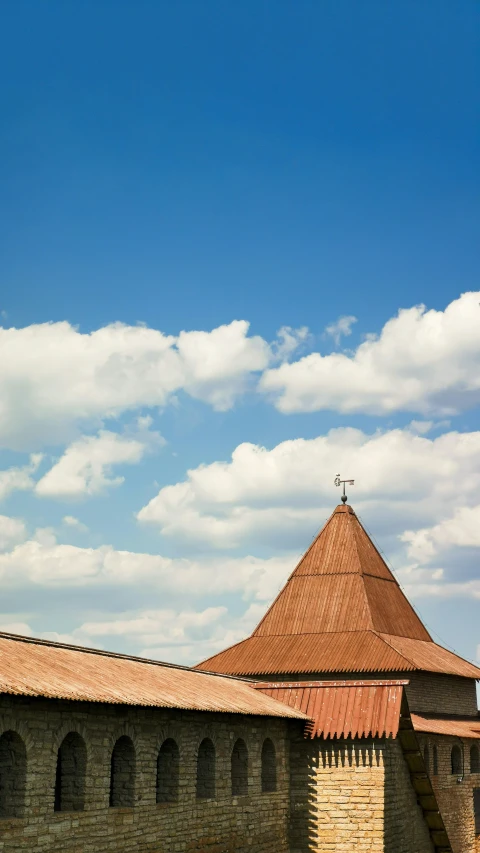 an old building with a tall tower and a cross on top