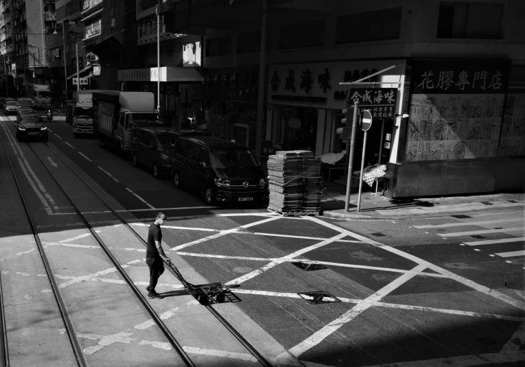 the woman is on her skateboard near some tracks