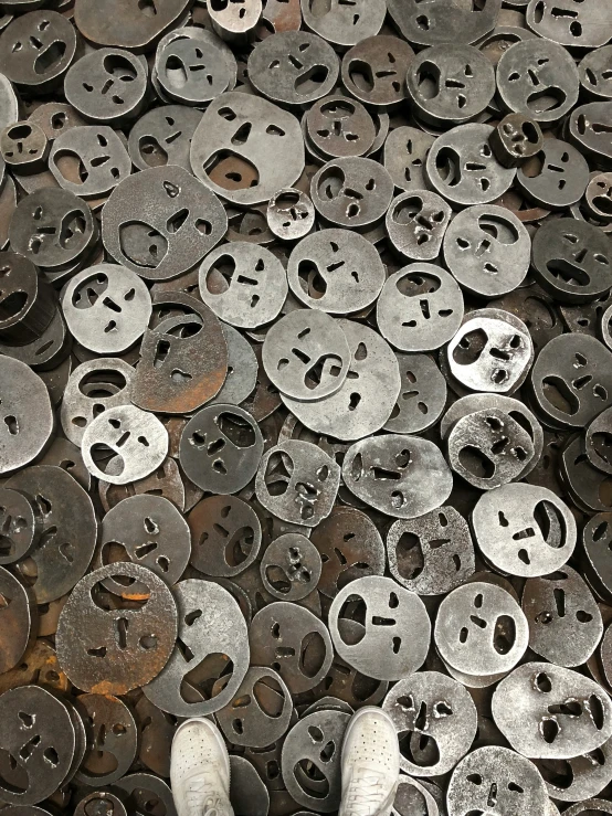 an array of silver plates with holes in the center