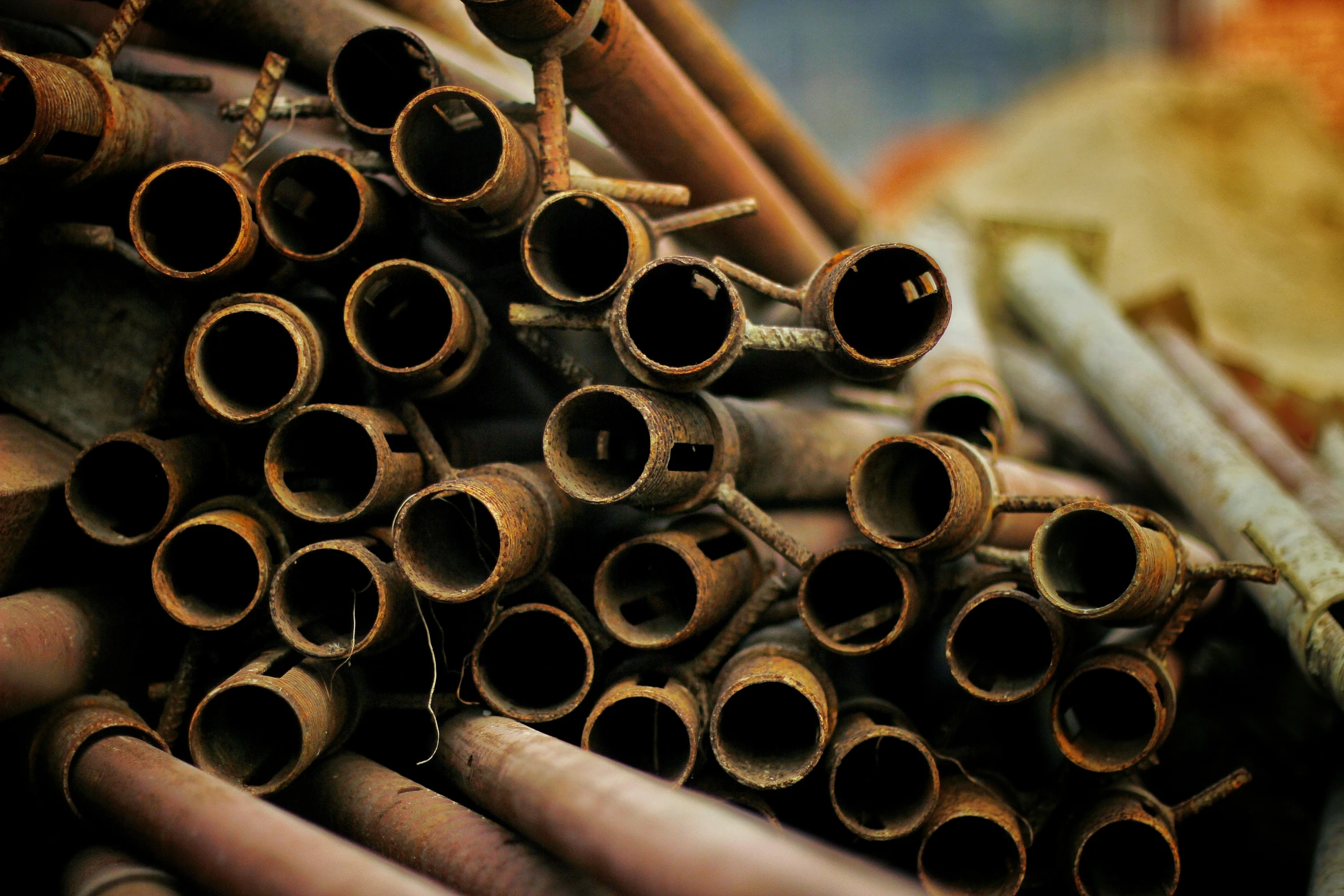 a pile of wooden pipes sitting in front of each other