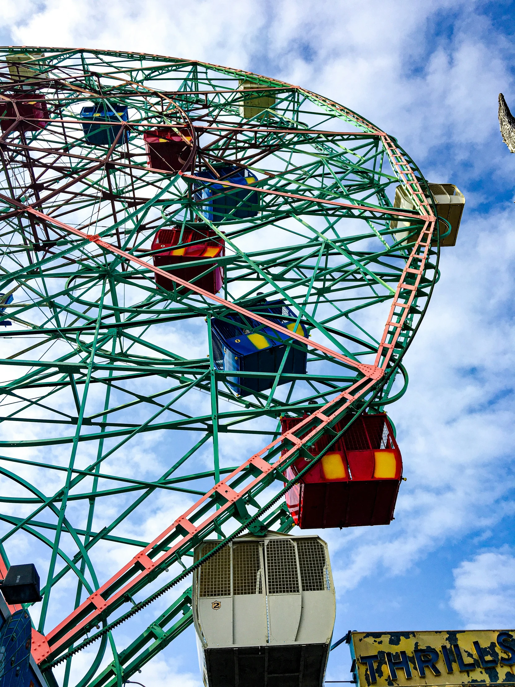 a ferris wheel and flags in the sky