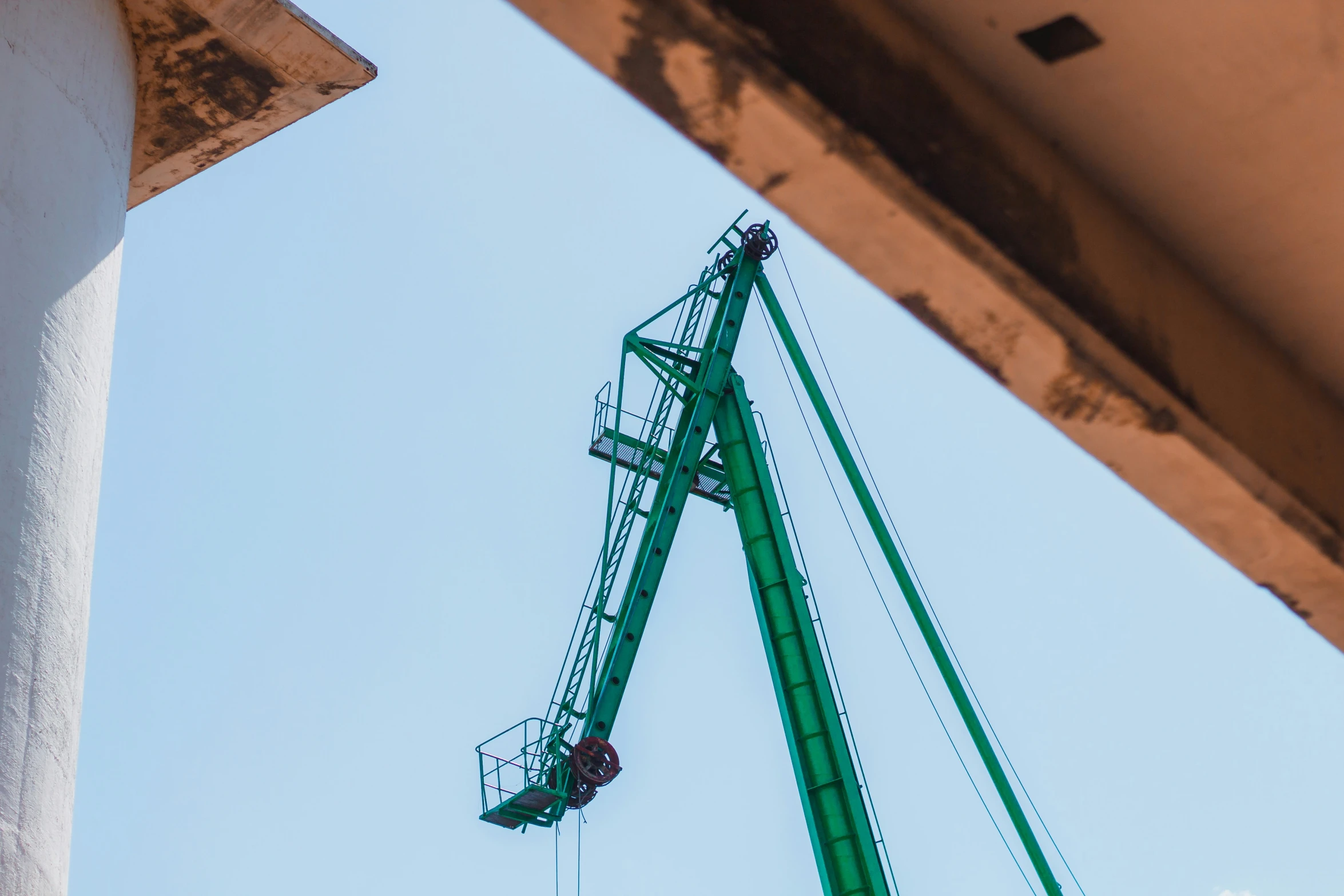 a crane and a building near some water