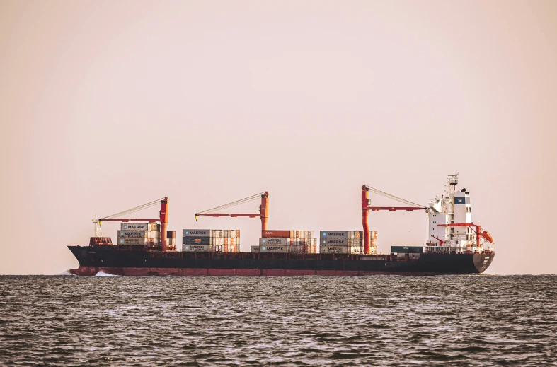 large boat carrying cargo sails through the sea