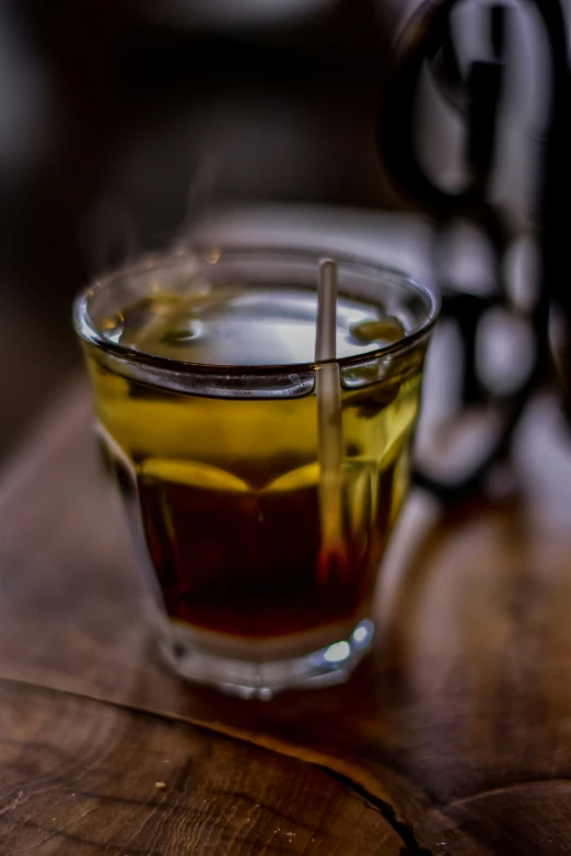 the glass has liquid in it on the table