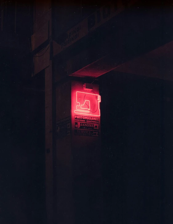 a street sign that is red with a light on it