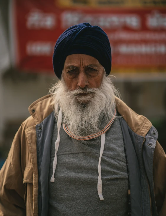 a man with a long gray beard and grey shirt