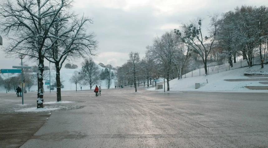 two people standing on the side walk of a road