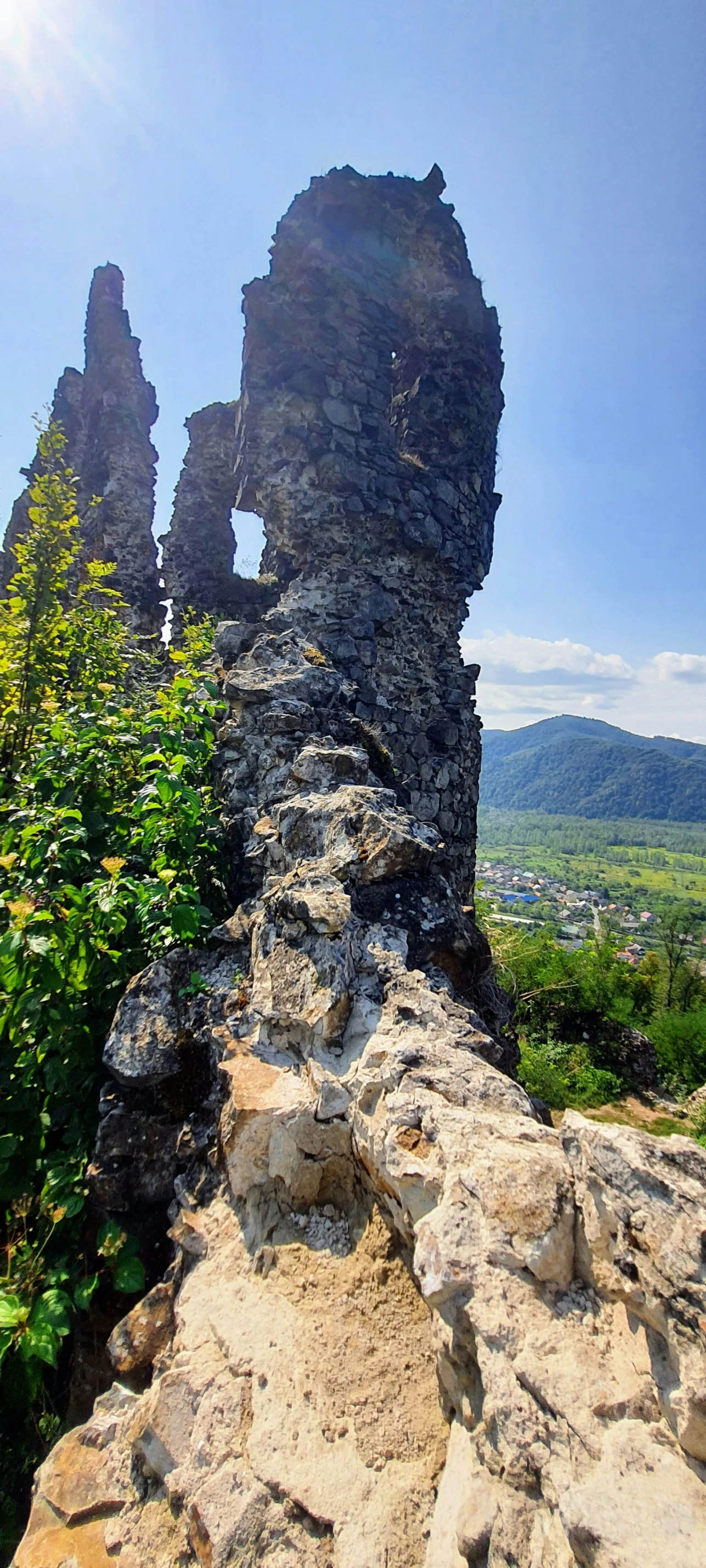 a stone rock formation with trees on both sides