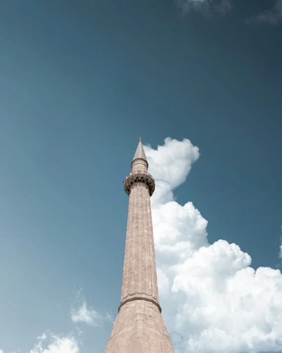 the tall clock tower is standing tall in the sky