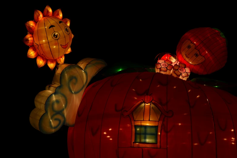 a lighted pumpkin on the top of a large animal