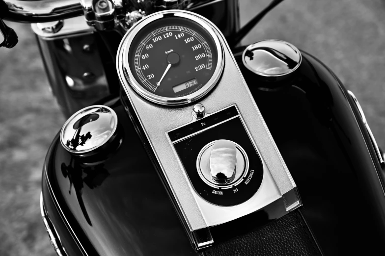 a motorcycle parked in a lot with a gauge