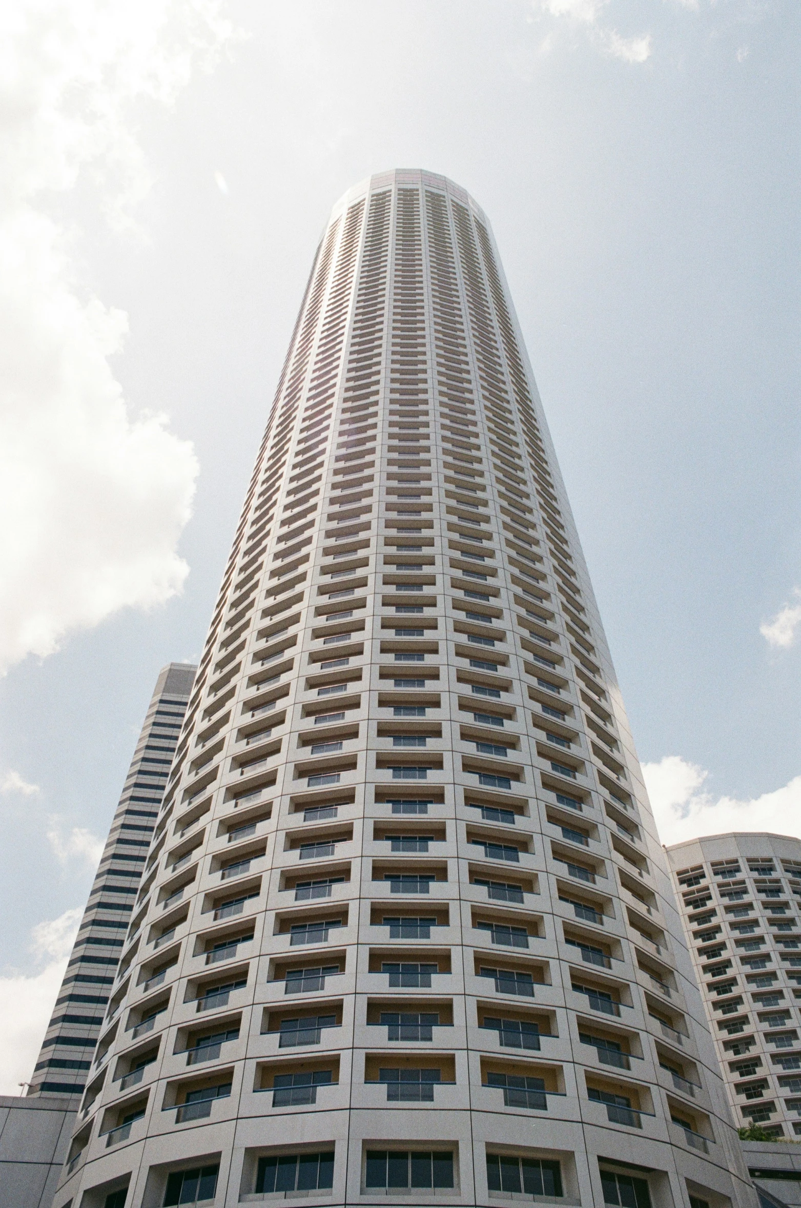 looking up at the sky from an empty lot in a tall building