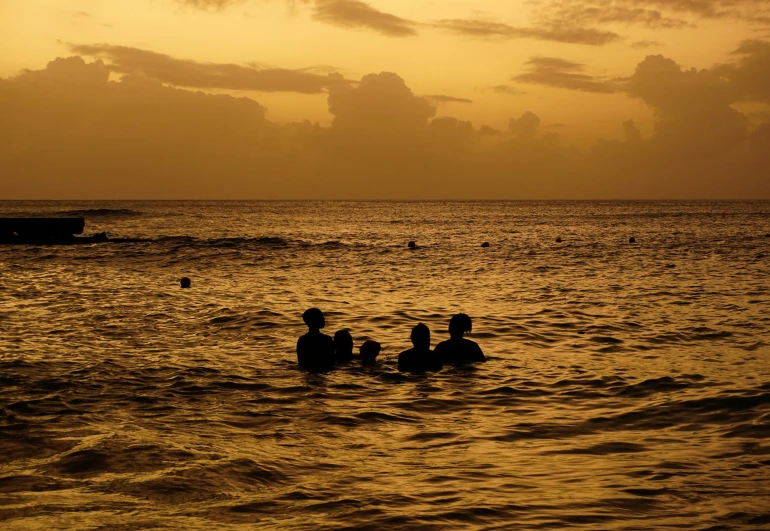 a couple of men are swimming in the water