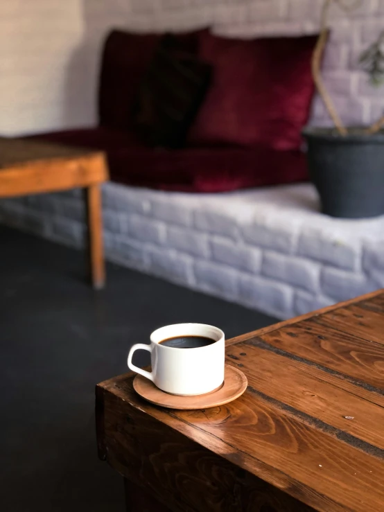 a mug is on a table near a couch