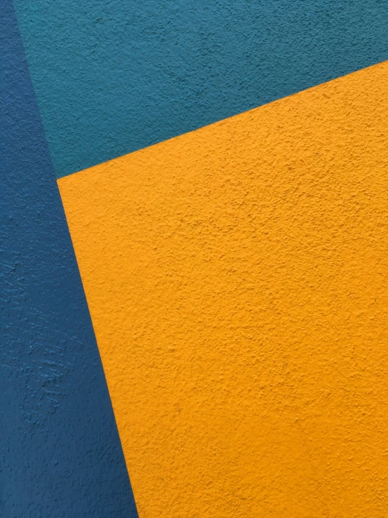 an empty bench in front of some multicolored building