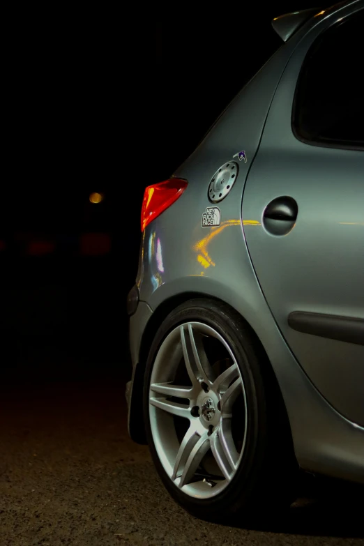 a close up view of the rear wheels of a small silver car