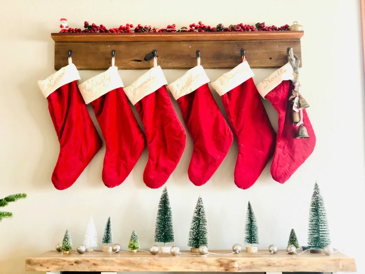 stockings hanging on a rack filled with fake holiday tree