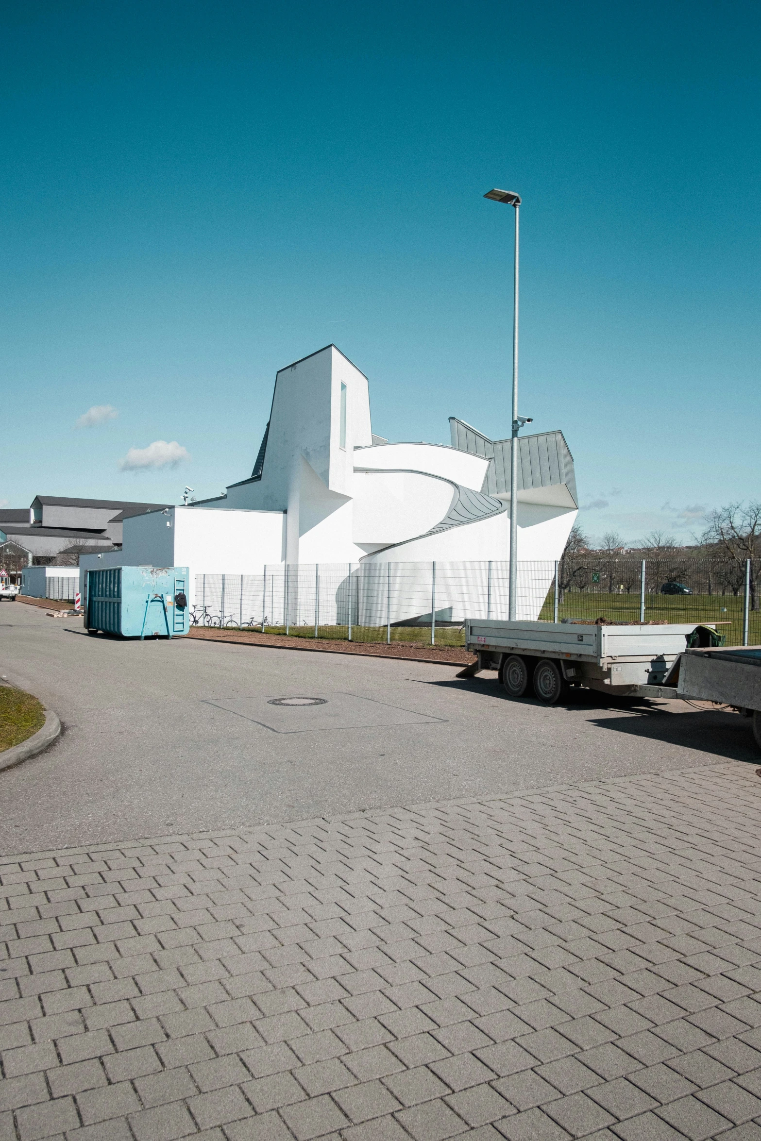 the large, white building with a curved metal staircase on the side of it