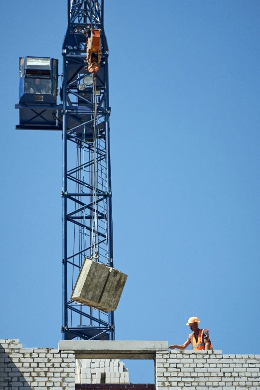 a construction worker works on a building being built