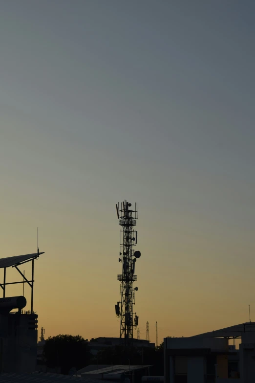 an airplane is in the sky and the silhouettes of the building