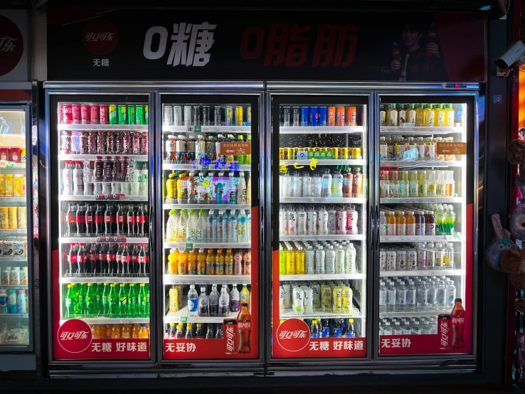 an assortment of soft drinks are displayed in a cooler