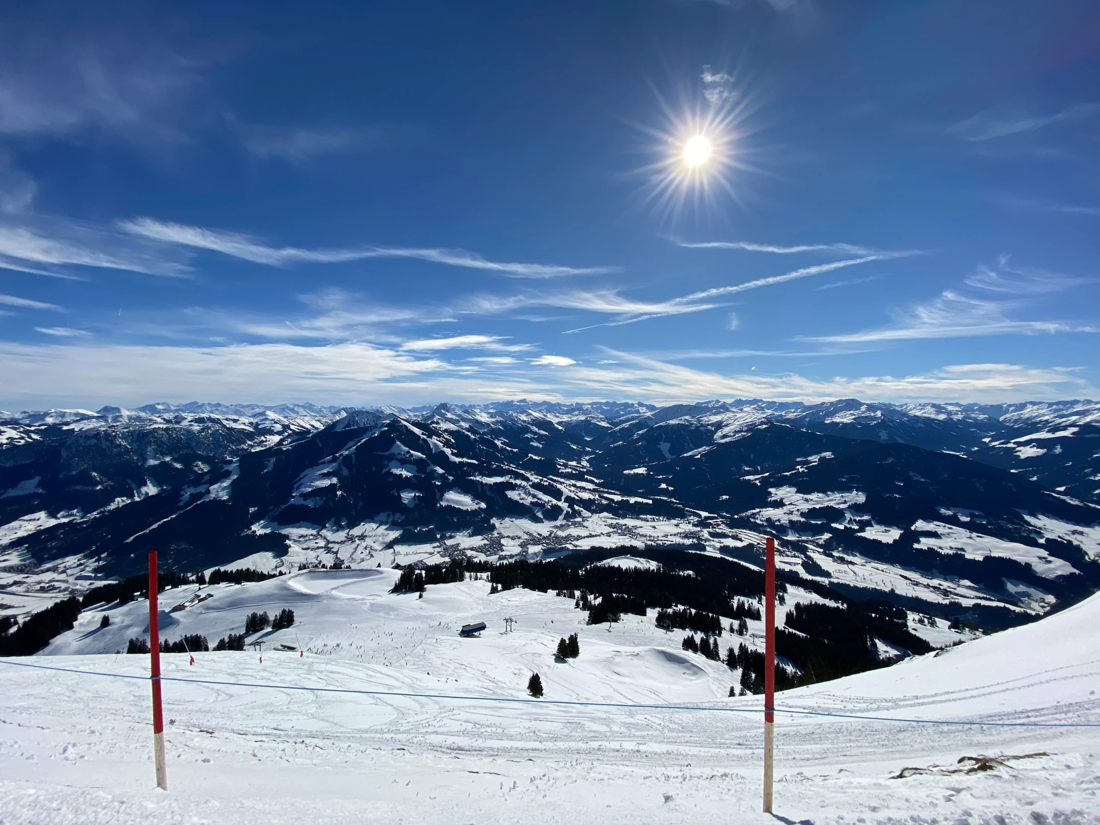 a sun rise is seen over the mountains