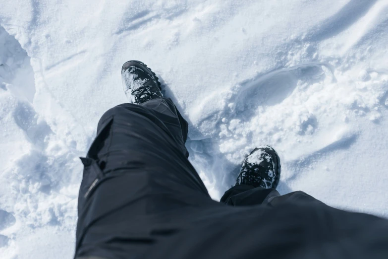 person wearing all black standing in the snow