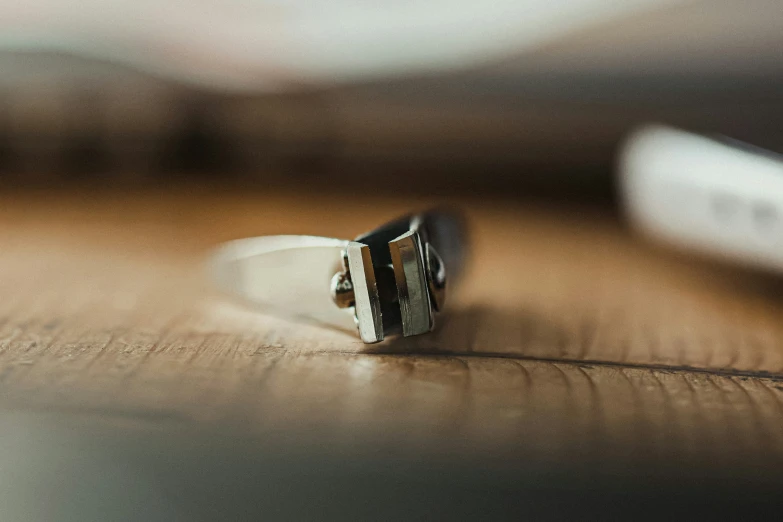 a single ring on top of a wooden table