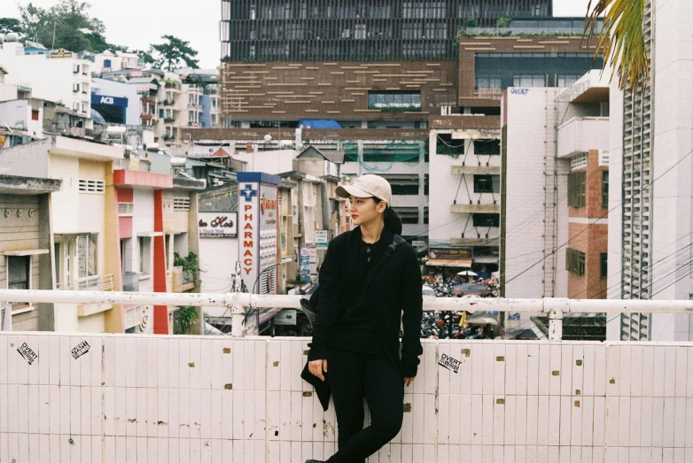 a man standing next to the top of a tall wall