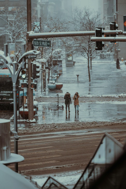 three people walking through a flooded street