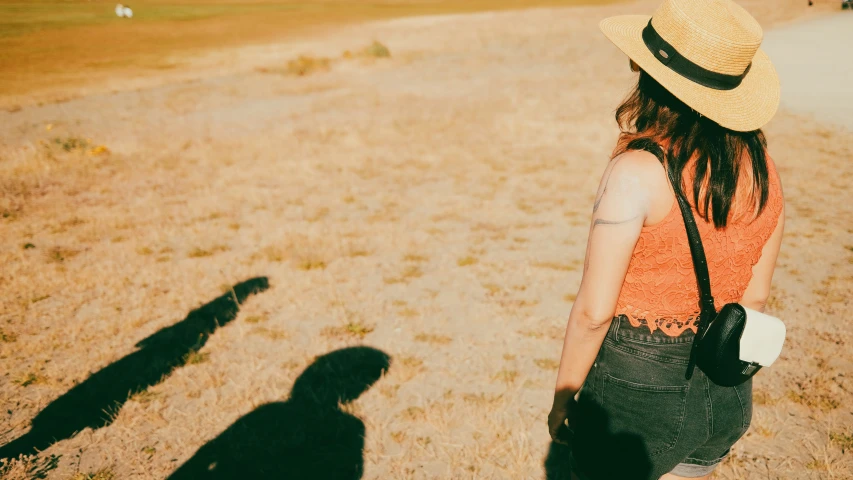 the woman is standing alone in the field