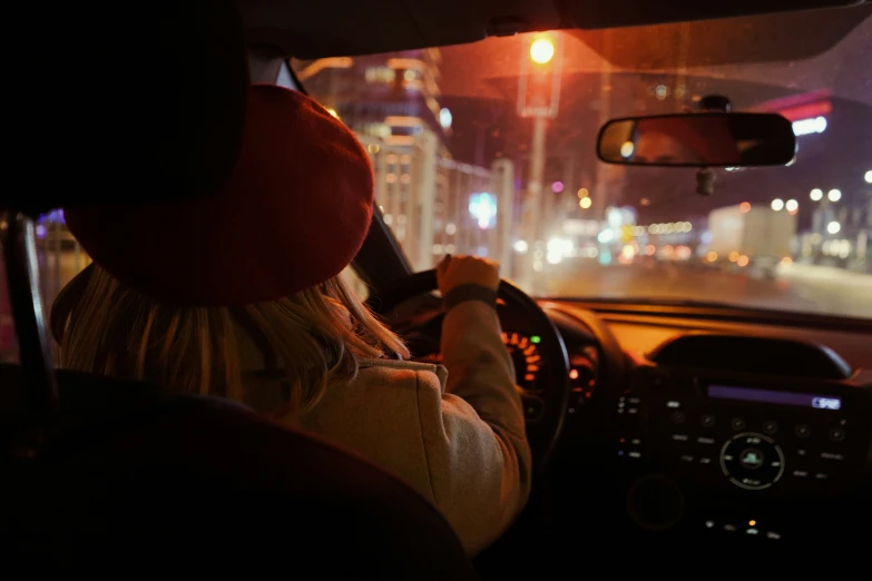 a person sits at the steering wheel of a car